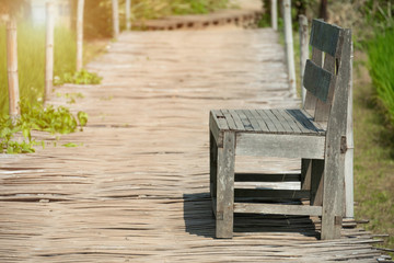 Fototapeta na wymiar Old wooden bench on the field.