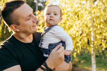 Happy younfather and her child enjoy the sunset outdoor  - Image