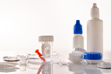 Accessories and products for contact lens maintenance on glass table
