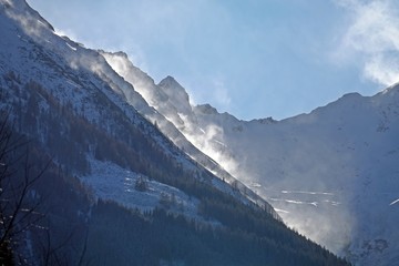 a very windy day on the mountains, but with sun and blue clear sky and with fresh snow
