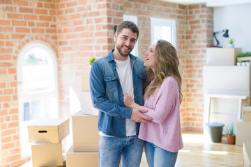 Young beautiful couple looking happy together moving to a new home