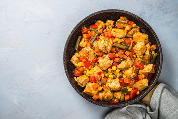 Obraz na płótnie Canvas Chicken stir fry with vegetables top view.