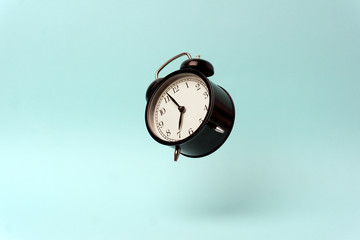 Vintage alarm clock on a blue clean background. Time management and time concept. Copy space