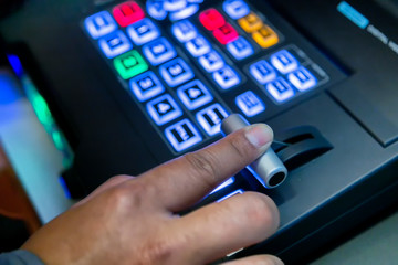  The sound mixer with hand is adjusting sound. Hand pressing the button on the audio mixer.