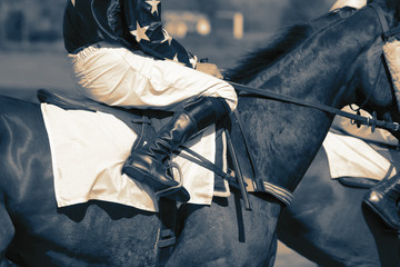 Horse racing jockeys riding horses preparing for the start of a race.  With colour toning