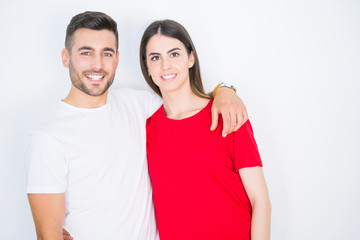 Young beautiful couple in love hugging over white isolated background
