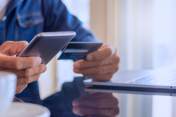 Man making online payment and shopping by mobile smart phone.
