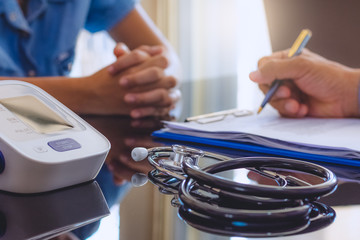 Male medicine doctor or practitioner and young female patient have counseling at the medical office desk .Medic care,medical and healthcare conceptual. 