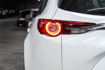 Close-up taillight of a new halogen white crossover car. Exterior of a modern car.