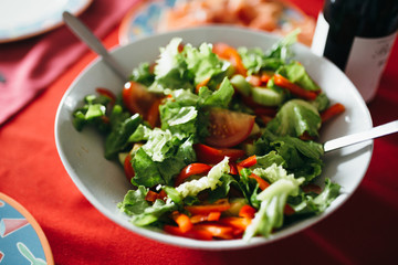 A bowl of green saland on the table