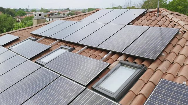solar energy panels installed on home rooftop, slow parallax circle aerial shot of domestic photovoltaic panel. Sustainable and renewable source of clean energy icon