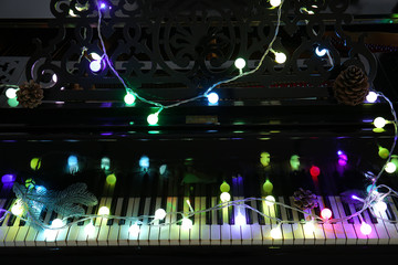 Piano with Christmas decor in darkness