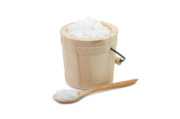 Closeup pure coarse natural sea salt in wooden bucket isolated on white background. Clipping path.