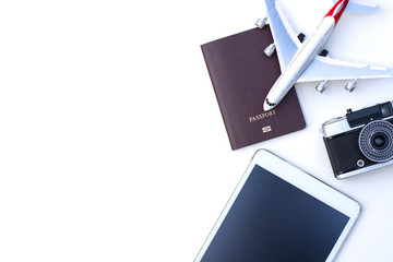 Mockup image of tablet computer with blank screen,passport,airplane,camera isolated on white background. Business trip and travel, leisure time concept. Work space for text and content.