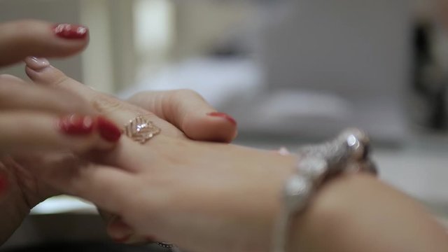 Shoping at the jeweler, women is fitting luxury jewelry. Concept:  luxury jewelry, an idea for a Christmas gift, black friday sales.