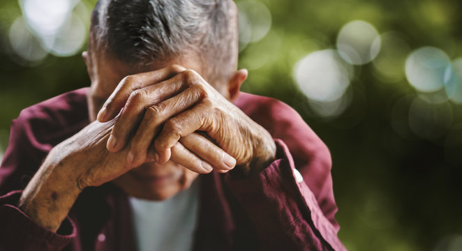 senior man covering his face with his hands. Depression and anxiety Copy space.