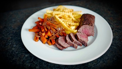 delicious fillet from venison with vegetables and fries