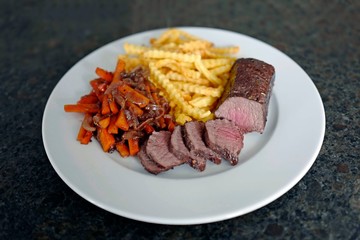 delicious fillet from venison with vegetables and fries