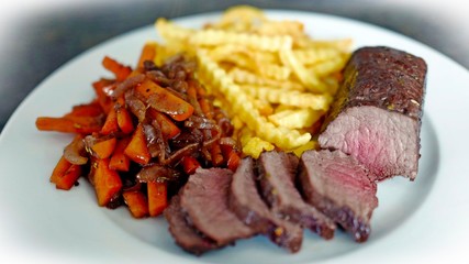 delicious fillet from venison with vegetables and fries