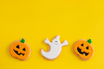 top view scary Halloween cookies on yellow background