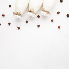 Copy space white background with milk and hazelnuts