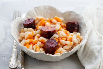 white beans with smoked sausage on beautiful dish