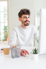 Young handsome man working using computer, smiling concentrated on internet