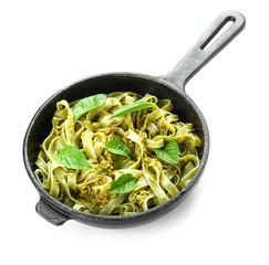 Frying pan with tasty pasta on white background
