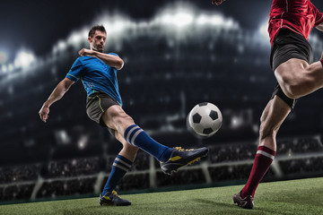Soccer player in action on night stadium background