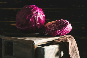 Tasty fresh cabbage on table against dark background