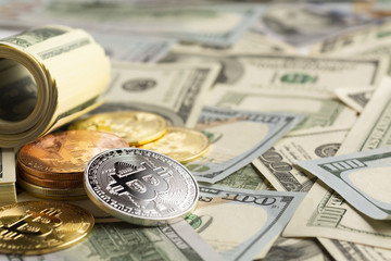 Bitcoin pile on top of dollar bills