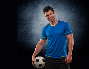 Soccer player in action on a dark background