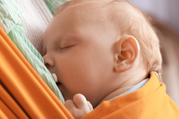 Young mother with little baby in sling, closeup