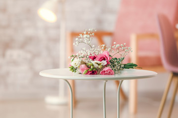 Beautiful fresh flowers on table in room