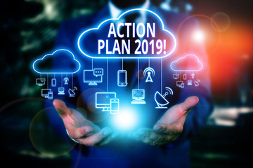 Writing note showing Action Plan 2019. Business concept for proposed strategy or course of actions for current year Male wear formal work suit presenting presentation smart device