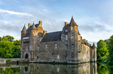 historic Chateau Trecesson castle in the Broceliande Forest with reflections in the pond