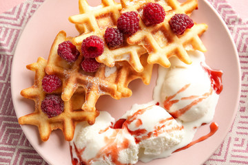 Plate with tasty waffles, berries and ice-cream on table, closeup