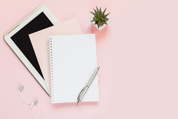 Top view of a flat lay of  desktop and notepads for writing down goals and plans. 2020 New Year's goal, plan, action text on  notepad with office accessories. Business motivation, inspiration concept.