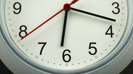 Fototapeta premium Close up White clock face beginning of time 06.18 am or pm. on black background, Copy space for your text, Time concept. .