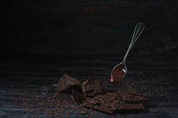 dark chocolate over wooden background