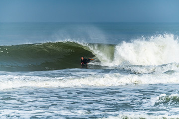 Bodyboarder surfing ocean wave