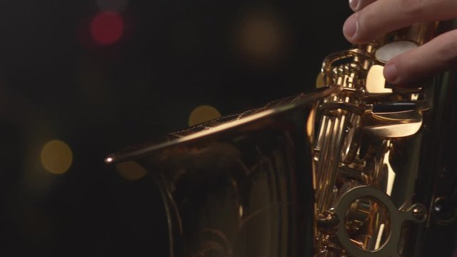 Close up Shot of Man Playing Saxophone. Christmas Light Bokeh