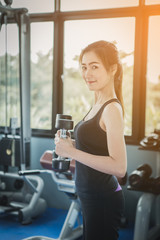 Fototapeta premium fitness woman doing exercises and warm up at gym ; healthy lifestyle