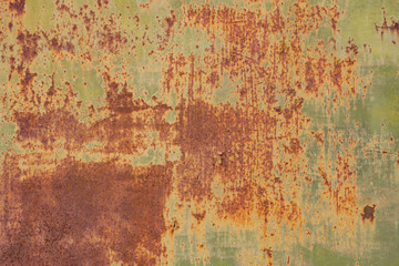 Rusty metal wall, old sheet of iron covered with rust and corrosion paint. Oxidized iron panel. Texture or background.