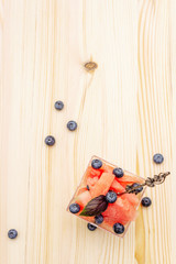 Fresh summer fruit dessert. Sweet watermelon and blueberry, purple basil leaves