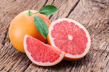 Grapefruits on old wooden background.