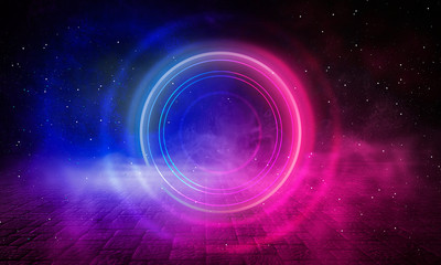 Neon circle on the background of a dark old brick wall, street, wet asphalt. Blue and pink neon, smoke, smog. Night view of the street with neon. Abstract neon dark background.