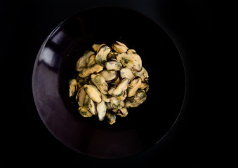 Cooked mussels isolated on black background