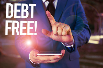 Text sign showing Debt Free. Business photo showcasing does not owning any money or things to any individual or companies Man with opened hands stands in suite. Concept with copy space and man