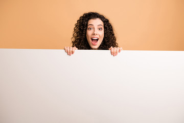 Photo of amazing lady indicating holding arms big white placard presenting novelty information wear white casual clothes isolated beige pastel color background